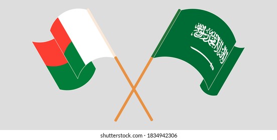 Crossed and waving flags of Madagascar and Kingdom of Saudi Arabia. Vector illustration

