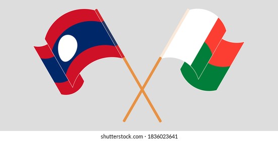 Crossed and waving flags of Madagascar and Laos. Vector illustration
