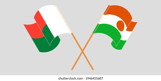 Crossed and waving flags of Madagascar and Niger