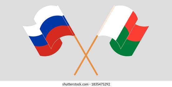 Crossed and waving flags of Madagascar and Russia. Vector illustration
