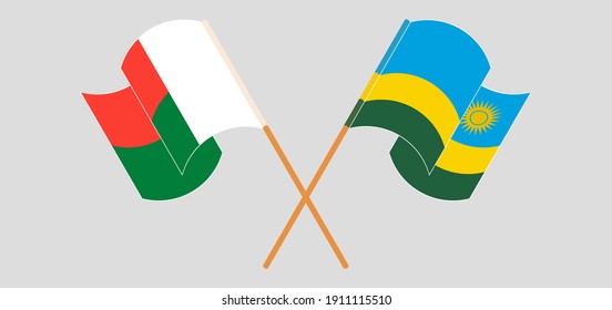 Crossed and waving flags of Madagascar and Rwanda