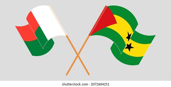 Crossed and waving flags of Madagascar and Sao Tome and Principe