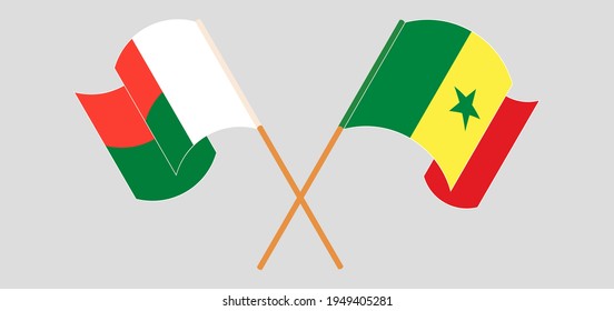 Gekreuzte und wehende Flaggen von Madagaskar und Senegal