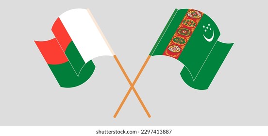 Crossed and waving flags of Madagascar and Turkmenistan