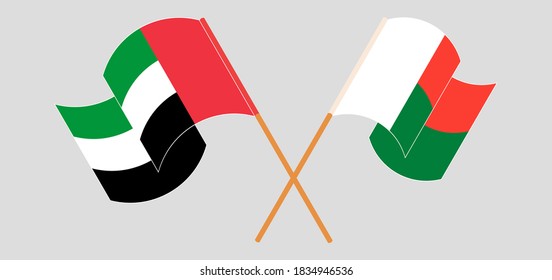 Crossed and waving flags of Madagascar and the United Arab Emirates. Vector illustration
