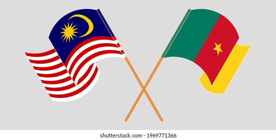 Crossed and waving flags of Malaysia and Cameroon
