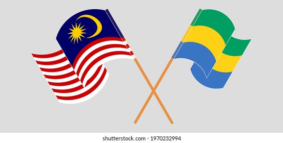 Crossed and waving flags of Malaysia and Gabon
