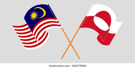 Crossed and waving flags of Malaysia and Greenland