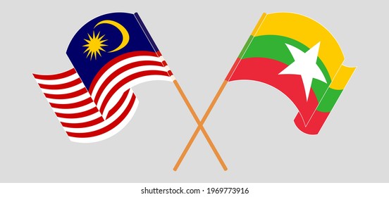 Crossed and waving flags of Malaysia and Myanmar