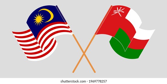 Crossed and waving flags of Malaysia and Oman