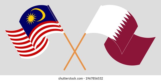 Crossed and waving flags of Malaysia and Qatar