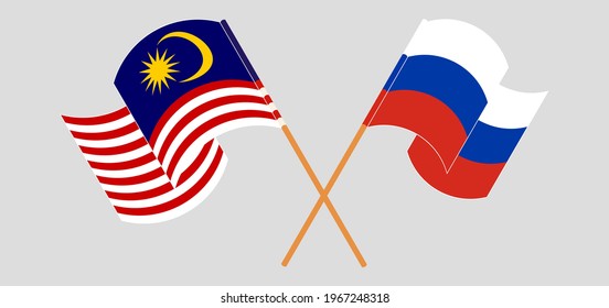 Crossed and waving flags of Malaysia and Russia
