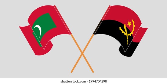 Crossed and waving flags of Maldives and Angola