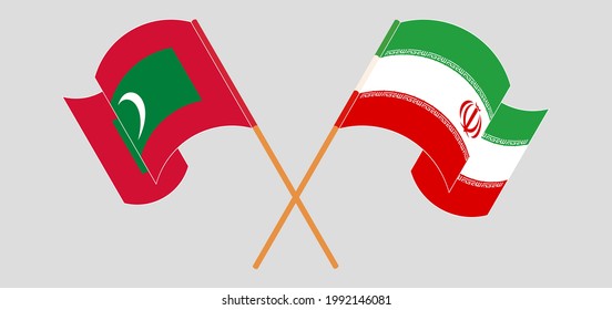 Crossed and waving flags of Maldives and Iran