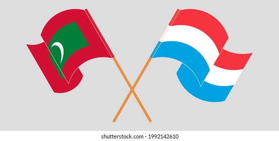 Crossed and waving flags of Maldives and Luxembourg