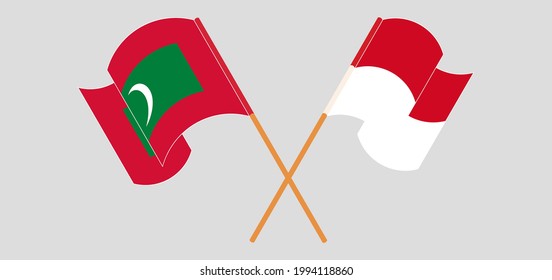 Crossed and waving flags of Maldives and Monaco