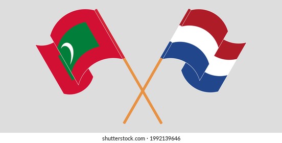 Crossed and waving flags of Maldives and the Netherlands