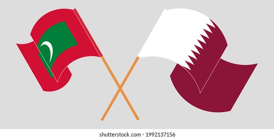 Crossed and waving flags of Maldives and Qatar