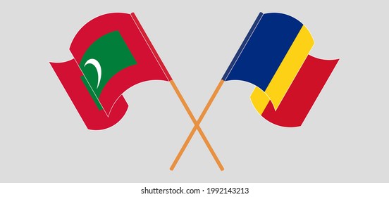 Crossed and waving flags of Maldives and Romania