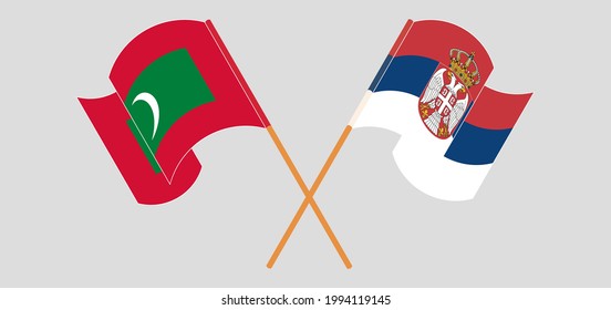 Crossed and waving flags of Maldives and Serbia