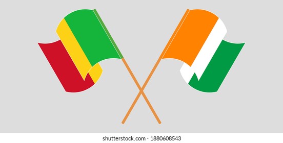 Crossed and waving flags of Mali and Republic of Ivory Coast