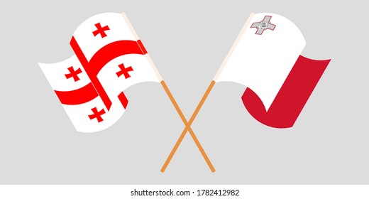 Crossed and waving flags of Malta and Georgia