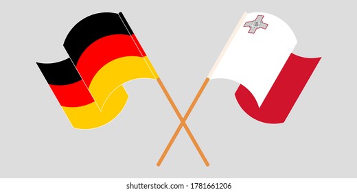Crossed and waving flags of Malta and Germany