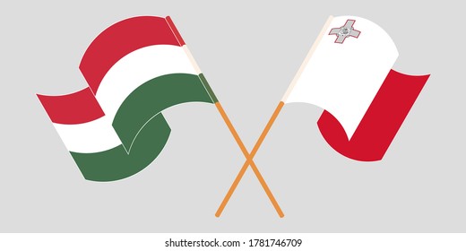 Crossed and waving flags of Malta and Hungary