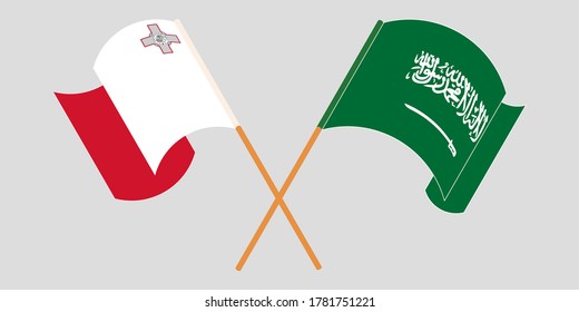 Banderas de Malta y del Reino de la Arabia Saudita cruzadas y ondeando banderas
