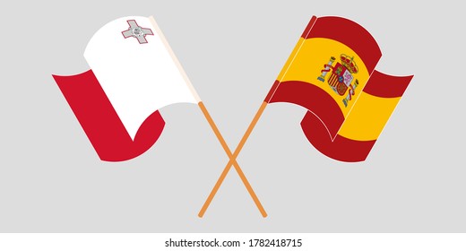 Crossed and waving flags of Malta and Spain