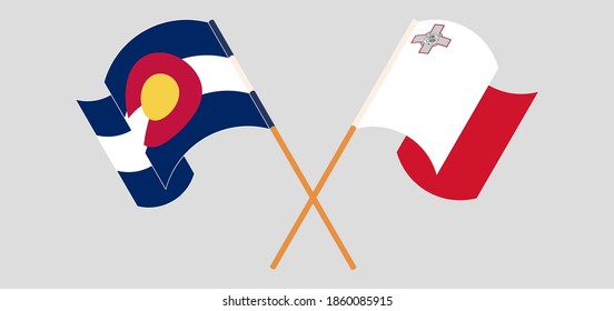 Crossed and waving flags of Malta and The State of Colorado