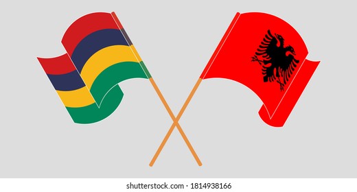 Crossed and waving flags of Mauritius and Albania