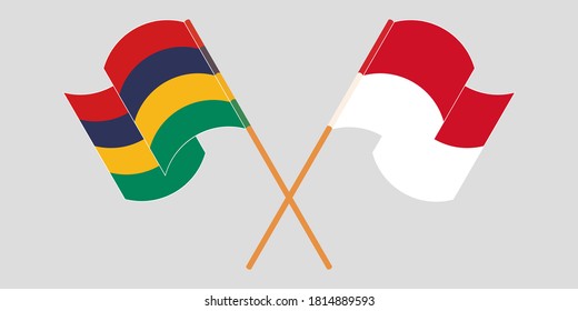 Crossed and waving flags of Mauritius and Indonesia