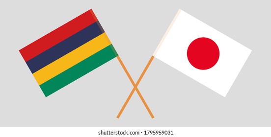 Crossed and waving flags of Mauritius and Japan