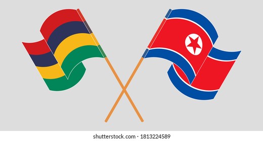 Crossed and waving flags of Mauritius and North Korea