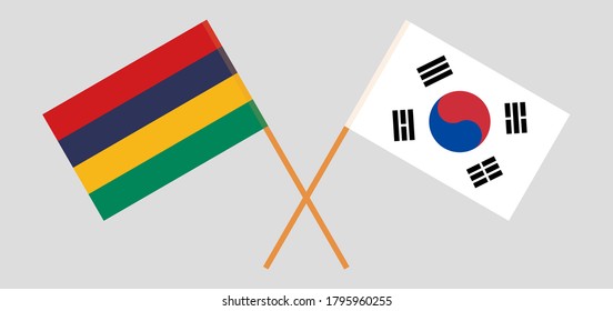 Crossed and waving flags of Mauritius and South Korea