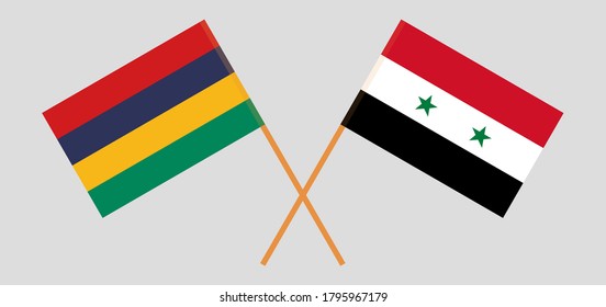 Crossed and waving flags of Mauritius and Syria