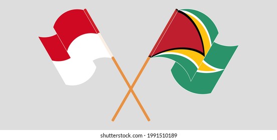 Crossed and waving flags of Monaco and Guyana