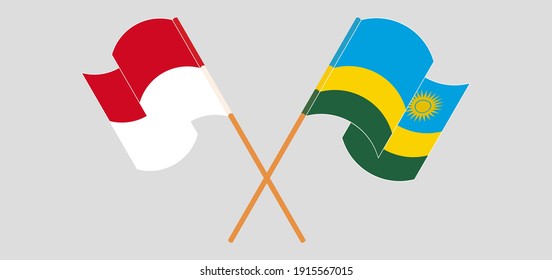 Crossed and waving flags of Monaco and Rwanda
