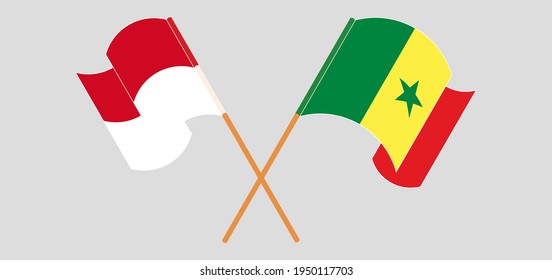 Crossed and waving flags of Monaco and Senegal