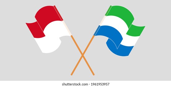 Crossed and waving flags of Monaco and Sierra Leone