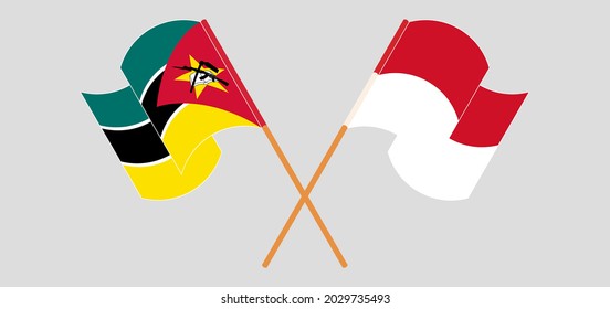 Crossed and waving flags of Mozambique and Indonesia
