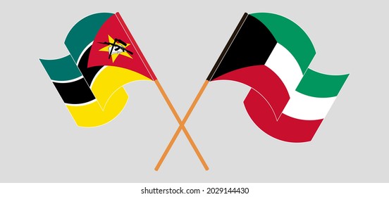 Crossed and waving flags of Mozambique and Kuwait