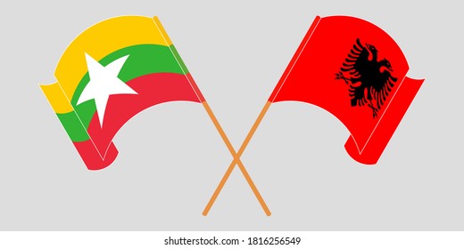 Crossed and waving flags of Myanmar and Albania