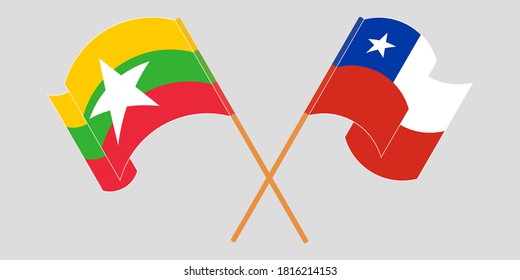 Crossed and waving flags of Myanmar and Chile