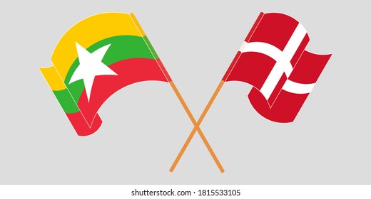 Banderas cruzadas y ondeando banderas de Myanmar y Dinamarca