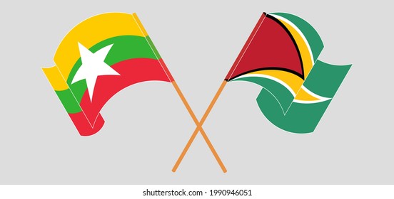 Banderas cruzadas y ondeando banderas de Myanmar y Guyana