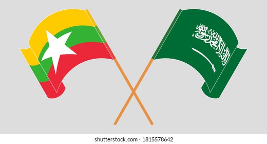 Crossed and waving flags of Myanmar and Kingdom of Saudi Arabia