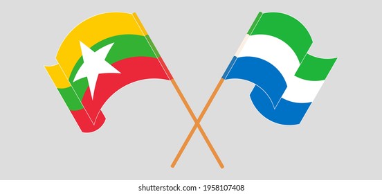 Crossed and waving flags of Myanmar and Sierra Leone