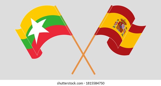 Crossed and waving flags of Myanmar and Spain
